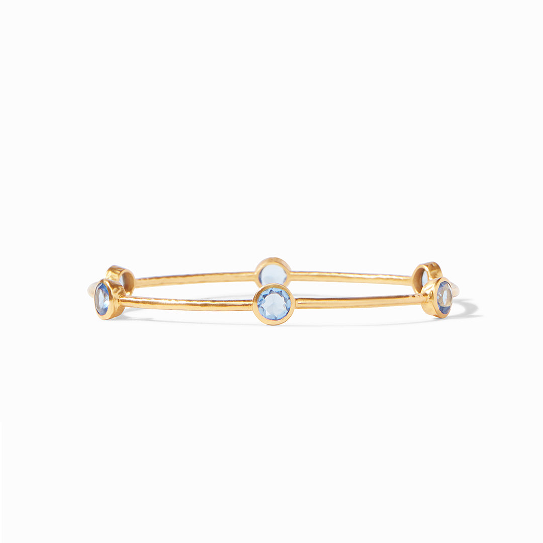 A lightly hammered bangle features six circular gemstones that sit along the length of this slim bangle, making it perfect for mixing and matching to create a striking color story on your wrist.