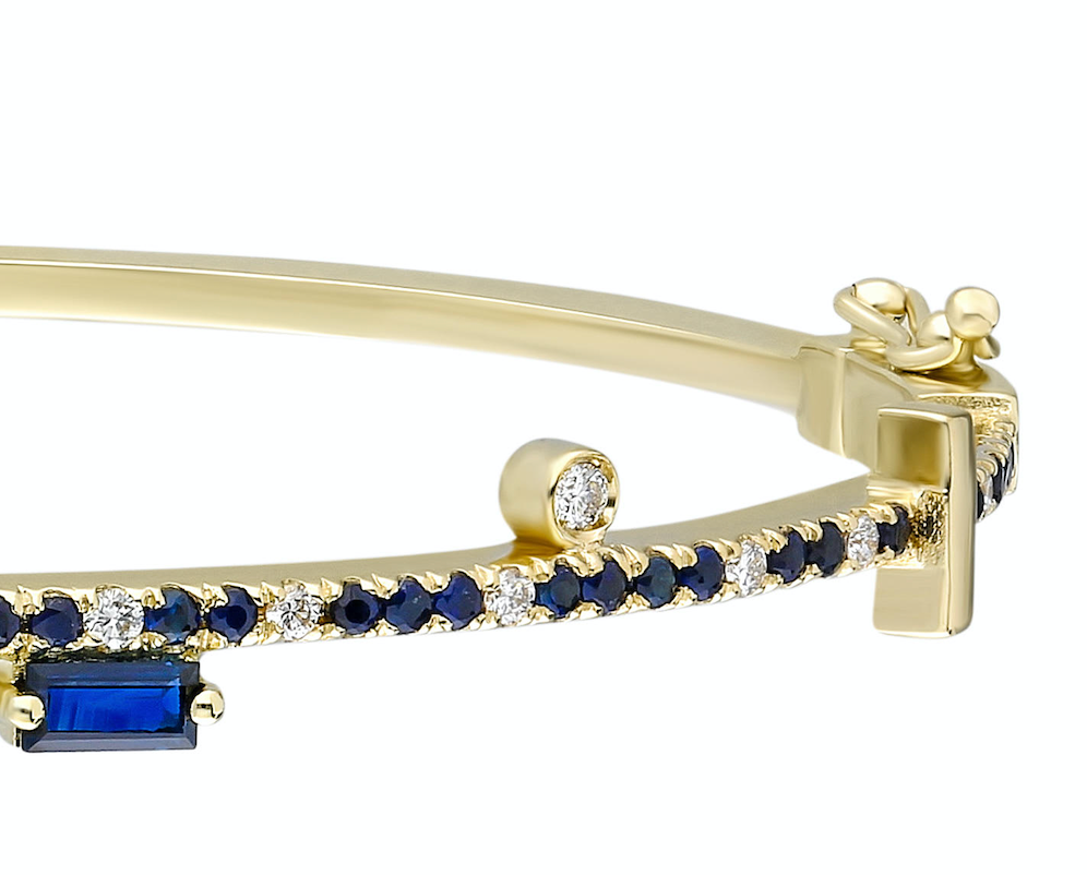 Blue sapphire and 14k yellow gold bangle with double clasp Blue sapphire: .57CT White diamonds: .16CT Blue sapphire trillion: .42CT Blue sapphire baguette: .16CT Made in Turkey
