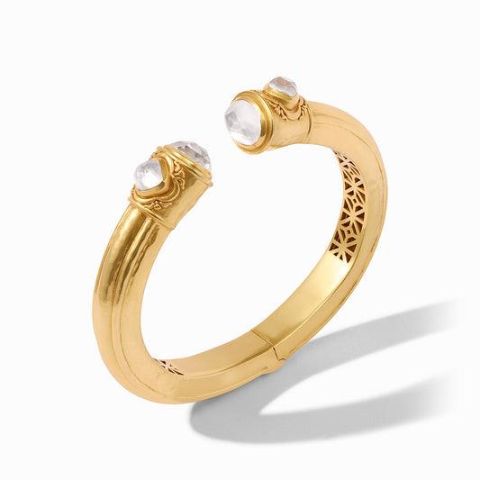 This opulent cuff features oval-shaped endcaps and diamond-shaped pearl accents and is designed with delicate piercework inside for lightness and luxury.
