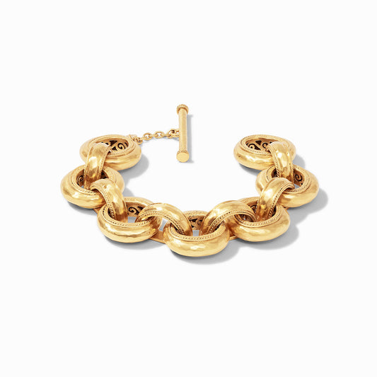 An elegant bracelet of lightly hammered golden links featuring a splendid pierced design on the inside and finished with a toggle.