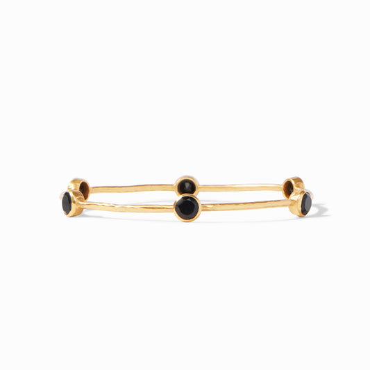 A lightly hammered bangle features six circular gemstones that sit along the length of this slim bangle, making it perfect for mixing and matching to create a striking color story on your wrist.