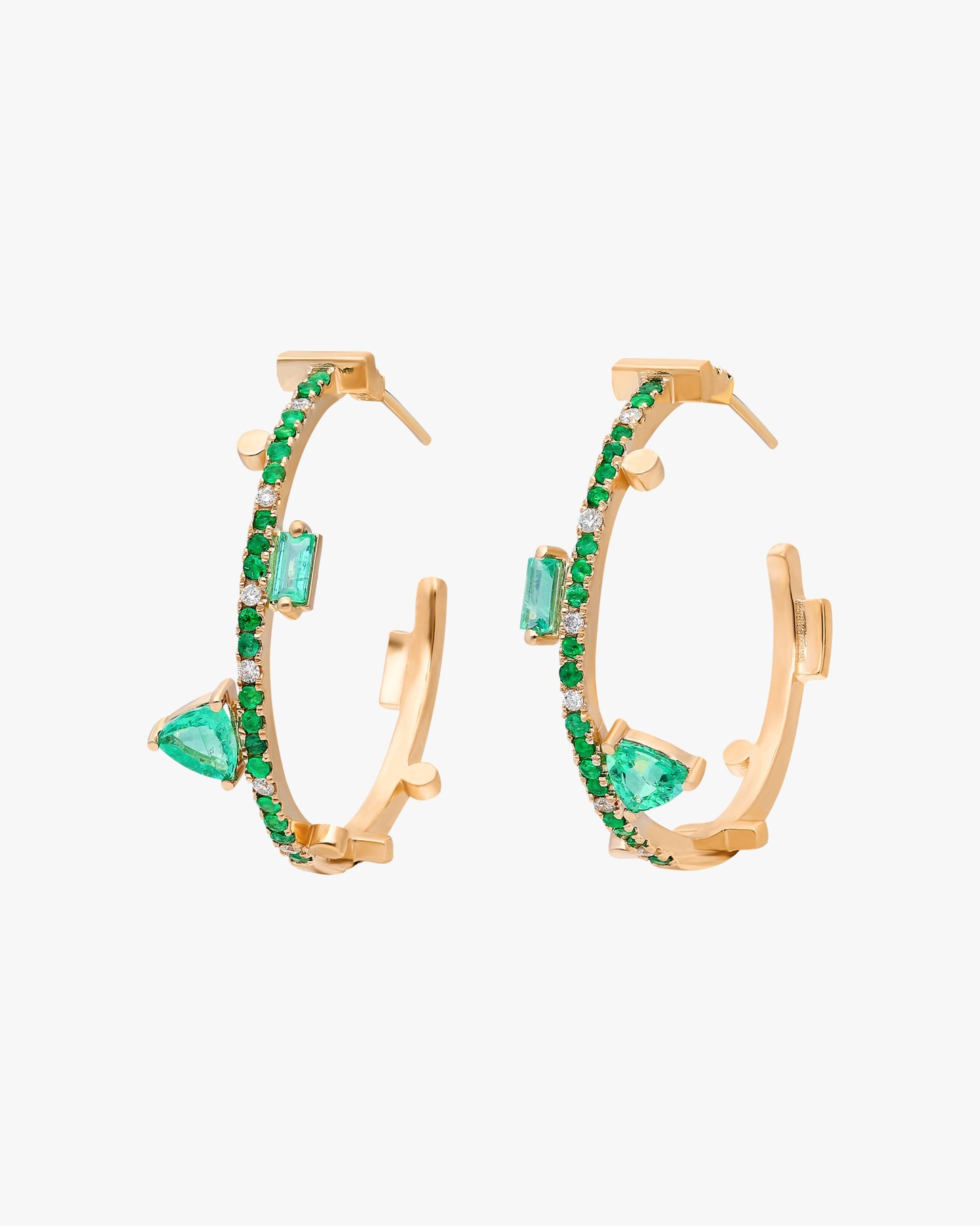 14k yellow gold and emerald Emerald: 1.56 tcw Spot clean Made in Turkey  Instantly enliven your ensemble with these 14k gold hoop earrings that are trimmed in vibrant emeralds and feature geometric stations for an edgy look. 