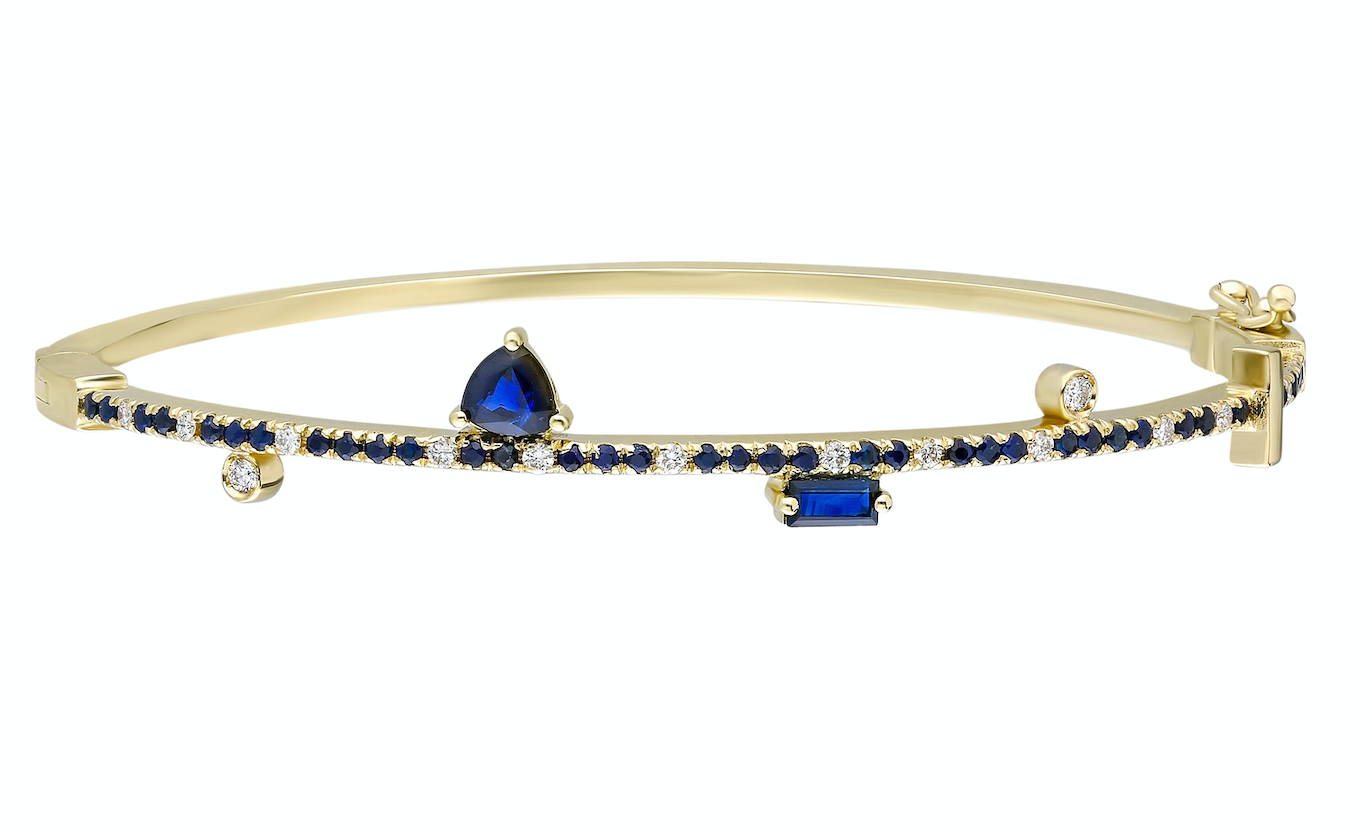 Blue sapphire and 14k yellow gold bangle with double clasp Blue sapphire: .57CT  White diamonds: .16CT  Blue sapphire trillion: .42CT  Blue sapphire baguette: .16CT  Made in Turkey