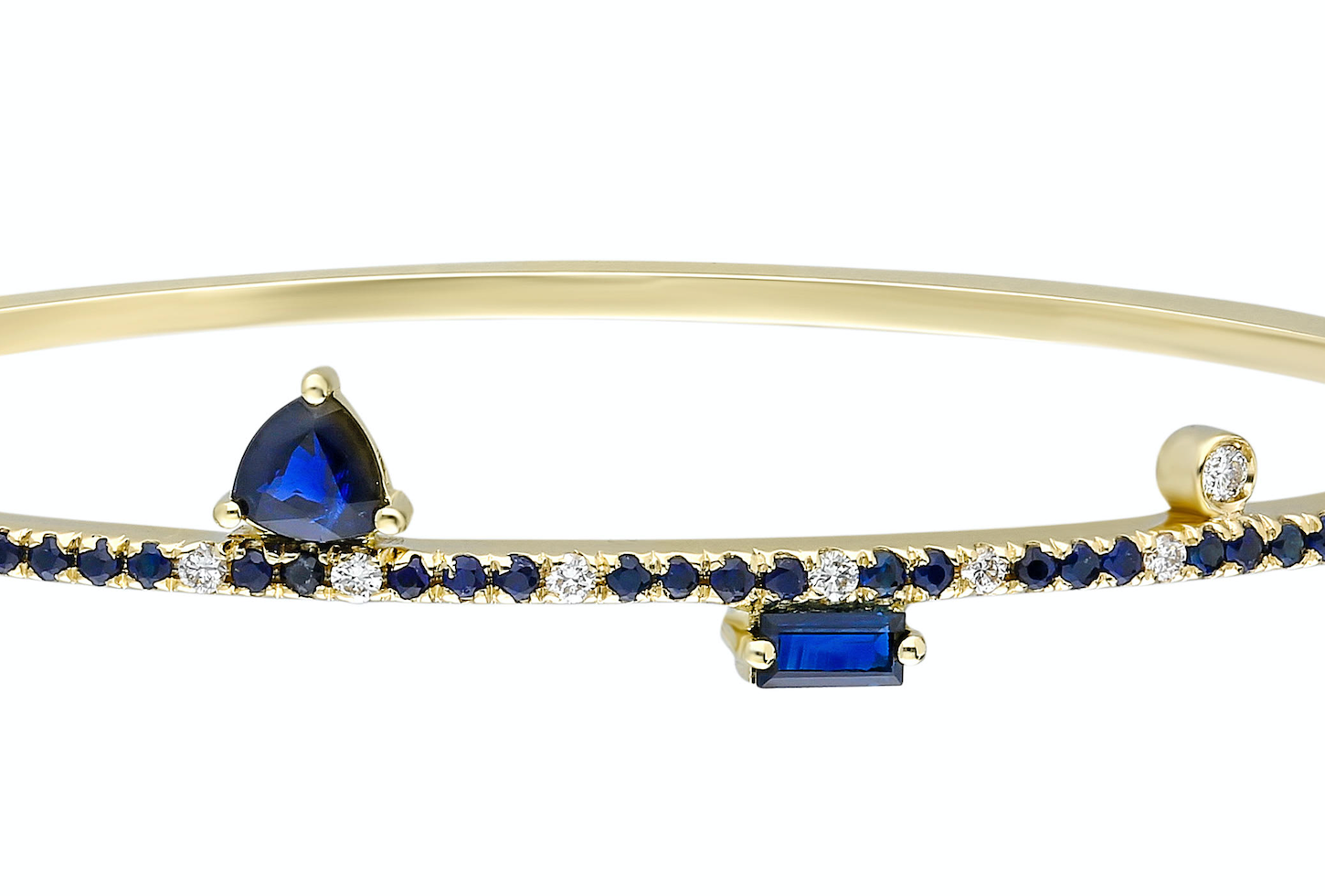 Blue sapphire and 14k yellow gold bangle with double clasp Blue sapphire: .57CT  White diamonds: .16CT  Blue sapphire trillion: .42CT  Blue sapphire baguette: .16CT  Made in Turkey